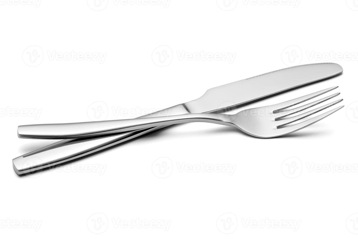 The metal shiny fork and knife on a white background. photo