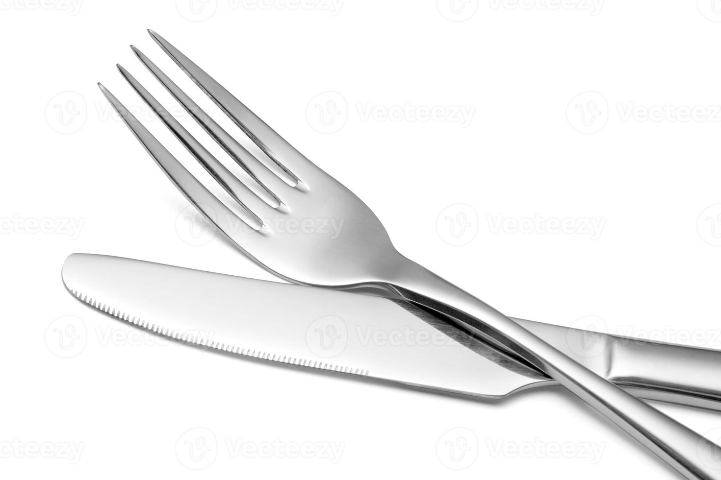 The metal shiny fork and knife on a white background. photo