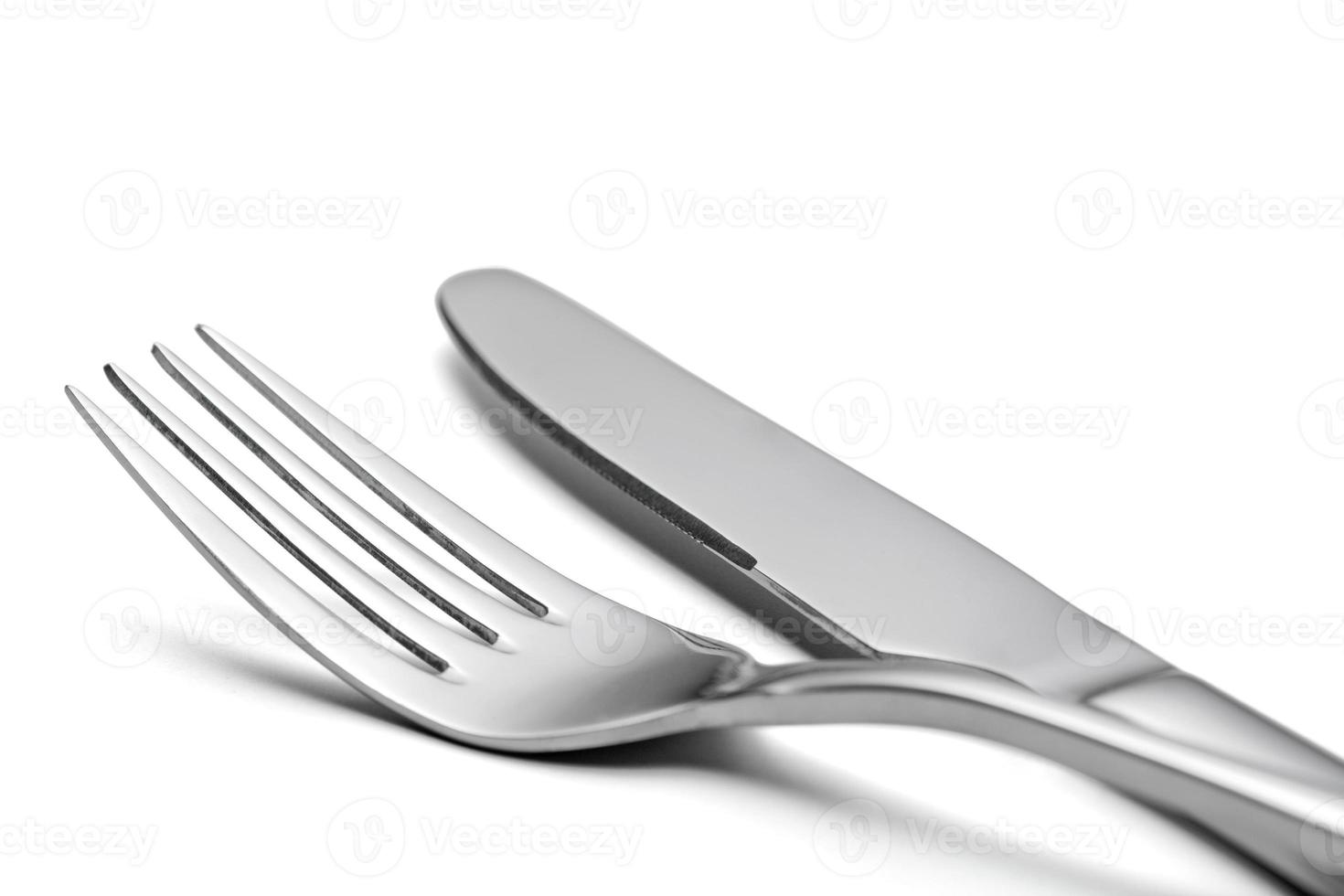 The metal shiny fork and knife on a white background. photo