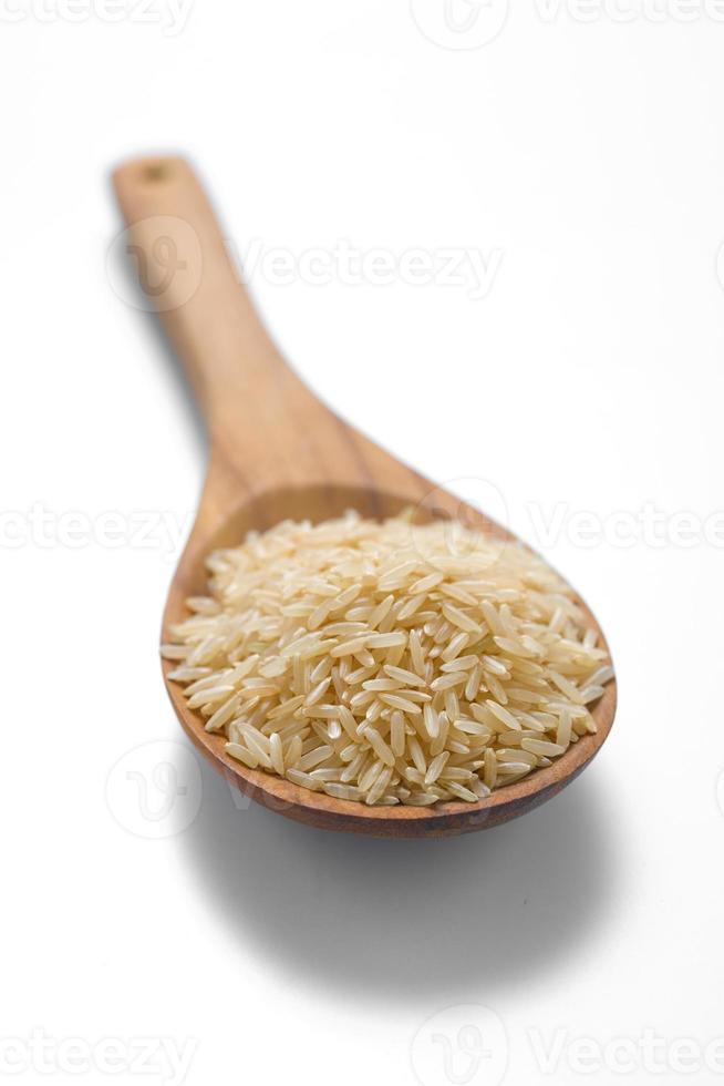 Brown rice in the wood spoon photo