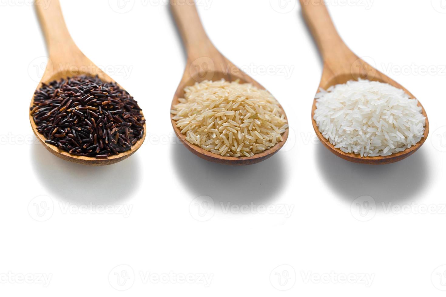 tres tipos de arroz en las cucharas de madera foto
