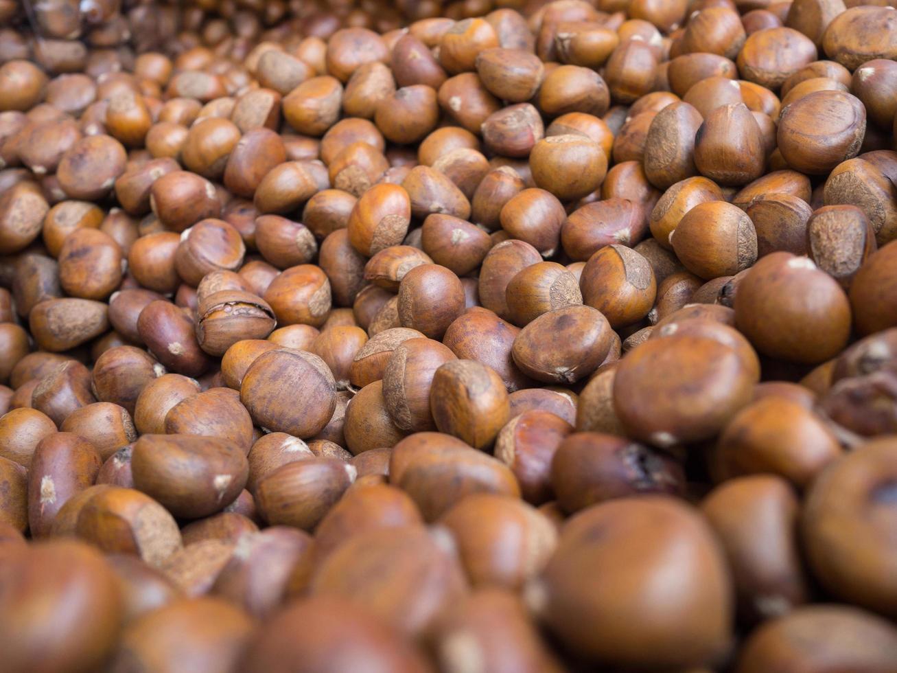 Pile of chestnuts roasted for sale in a market photo