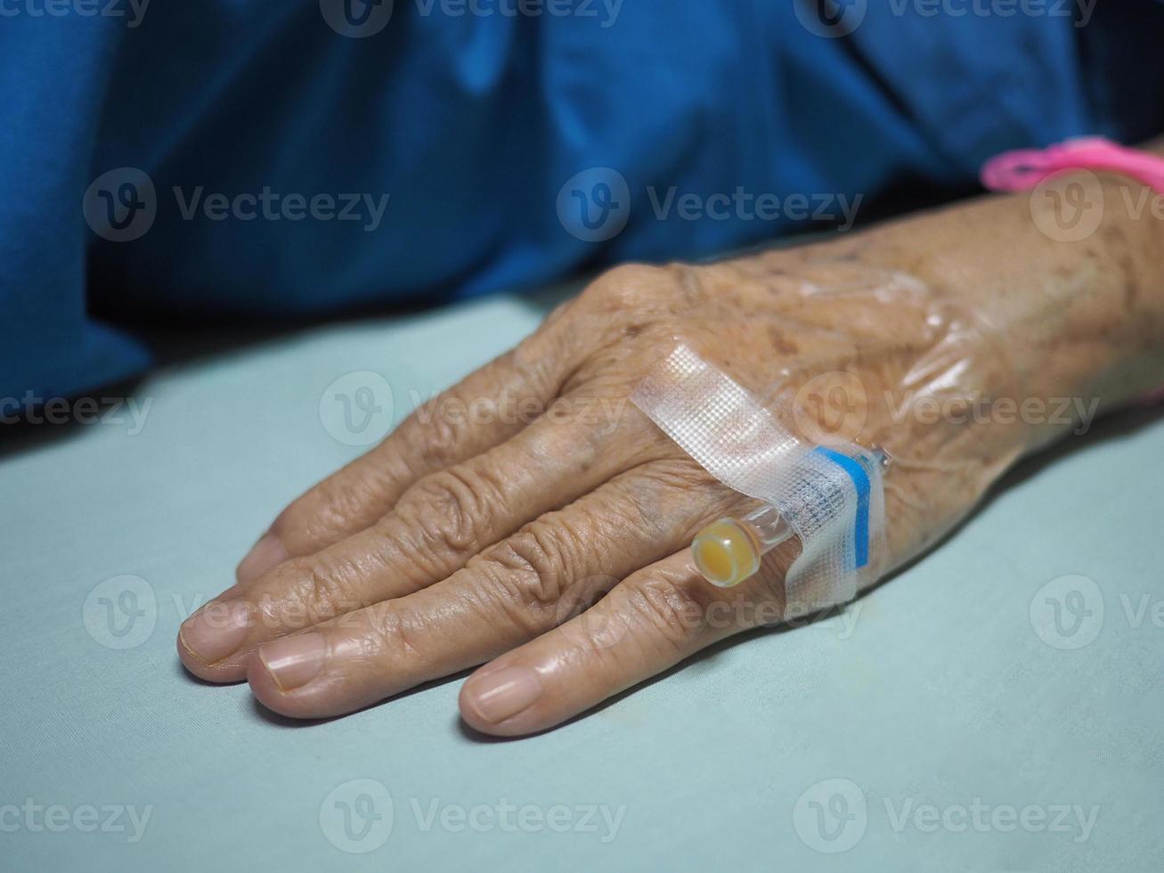 Close-up of senior woman hand patient admitted to the hospital photo