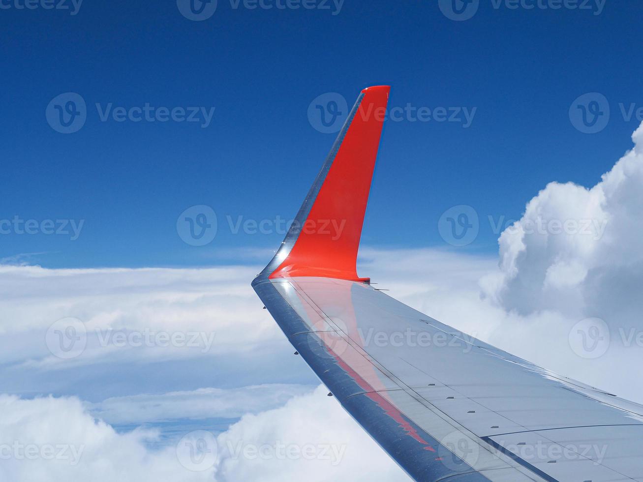 Aerial view of sky seen through airplane window photo