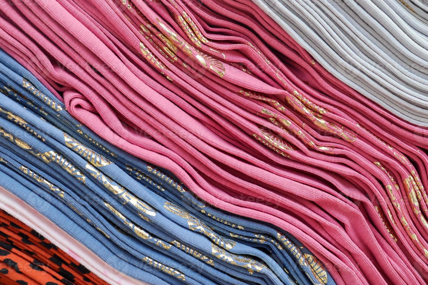 Detailed close up view on samples of cloth and fabrics in different colors found at a fabrics market photo