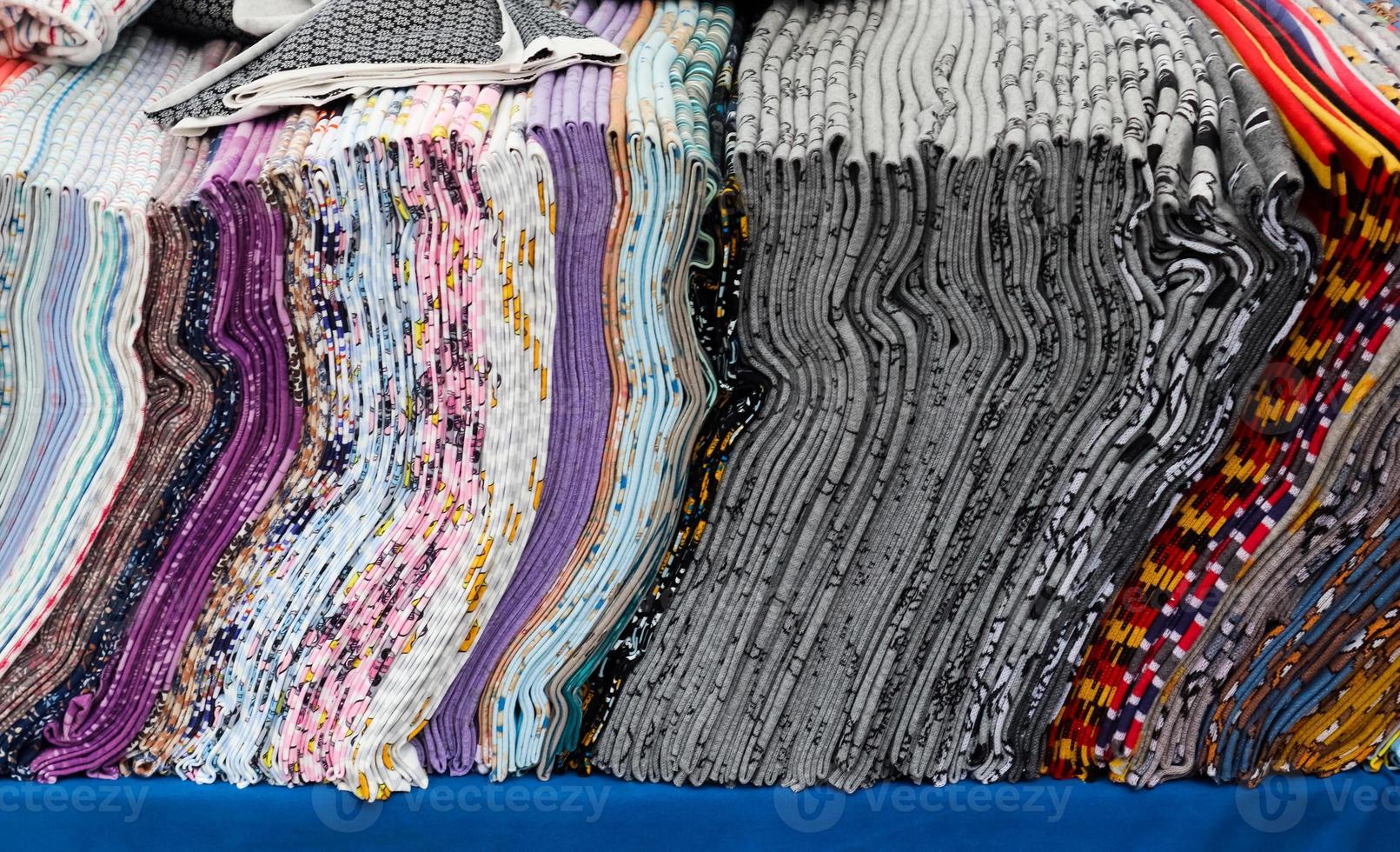Close up view on samples of cloth and fabrics in different colors found at a fabrics market photo