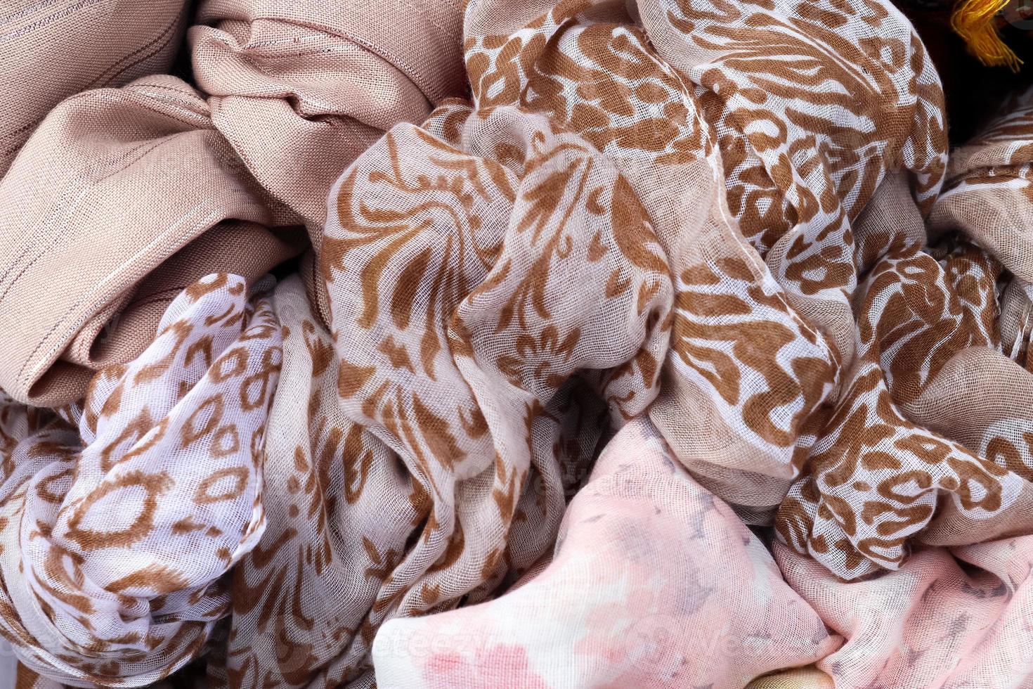 Detailed close up view on samples of cloth and fabrics in different colors found at a fabrics market photo