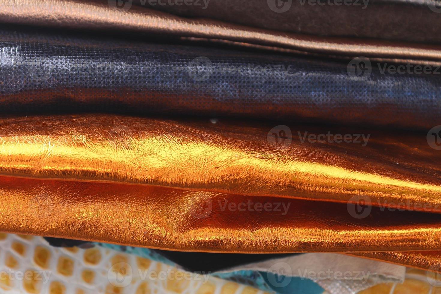 Detailed close up view on samples of cloth and fabrics in different colors found at a fabrics market photo