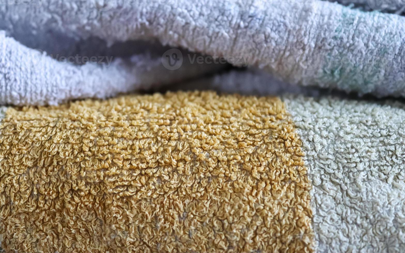 Detailed close up view on samples of cloth and fabrics in different colors found at a fabrics market photo