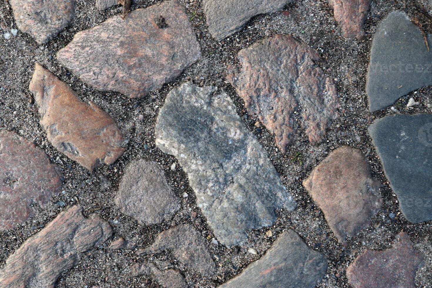 Detailed close up on old historical cobblestone roads and walkways photo