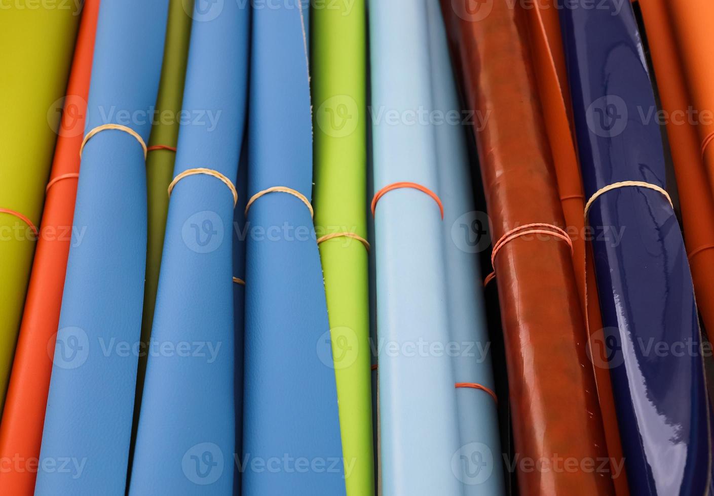 Detailed close up view on samples of cloth and fabrics in different colors found at a fabrics market photo