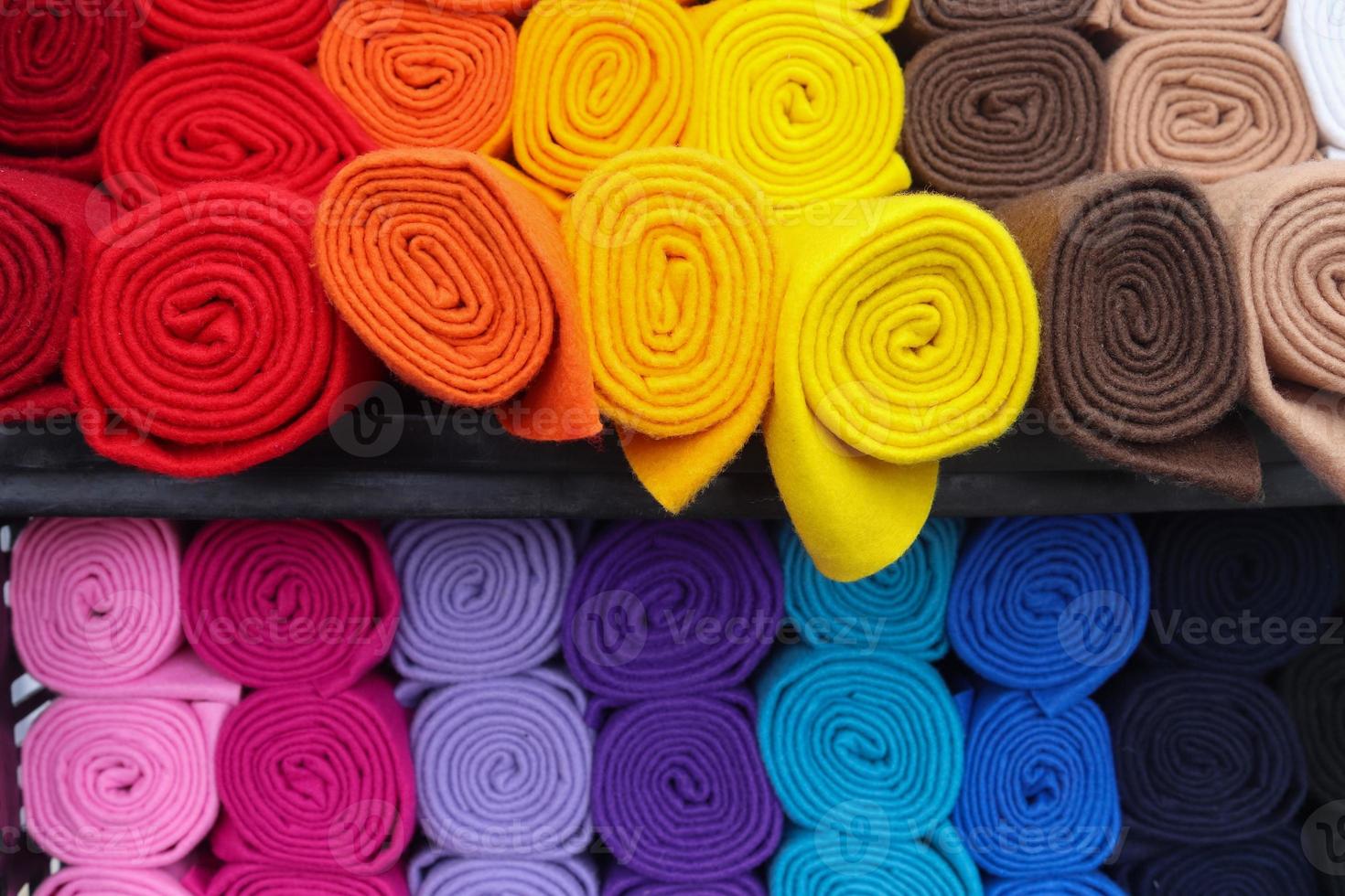 Detailed close up view on samples of cloth and fabrics in different colors found at a fabrics market photo