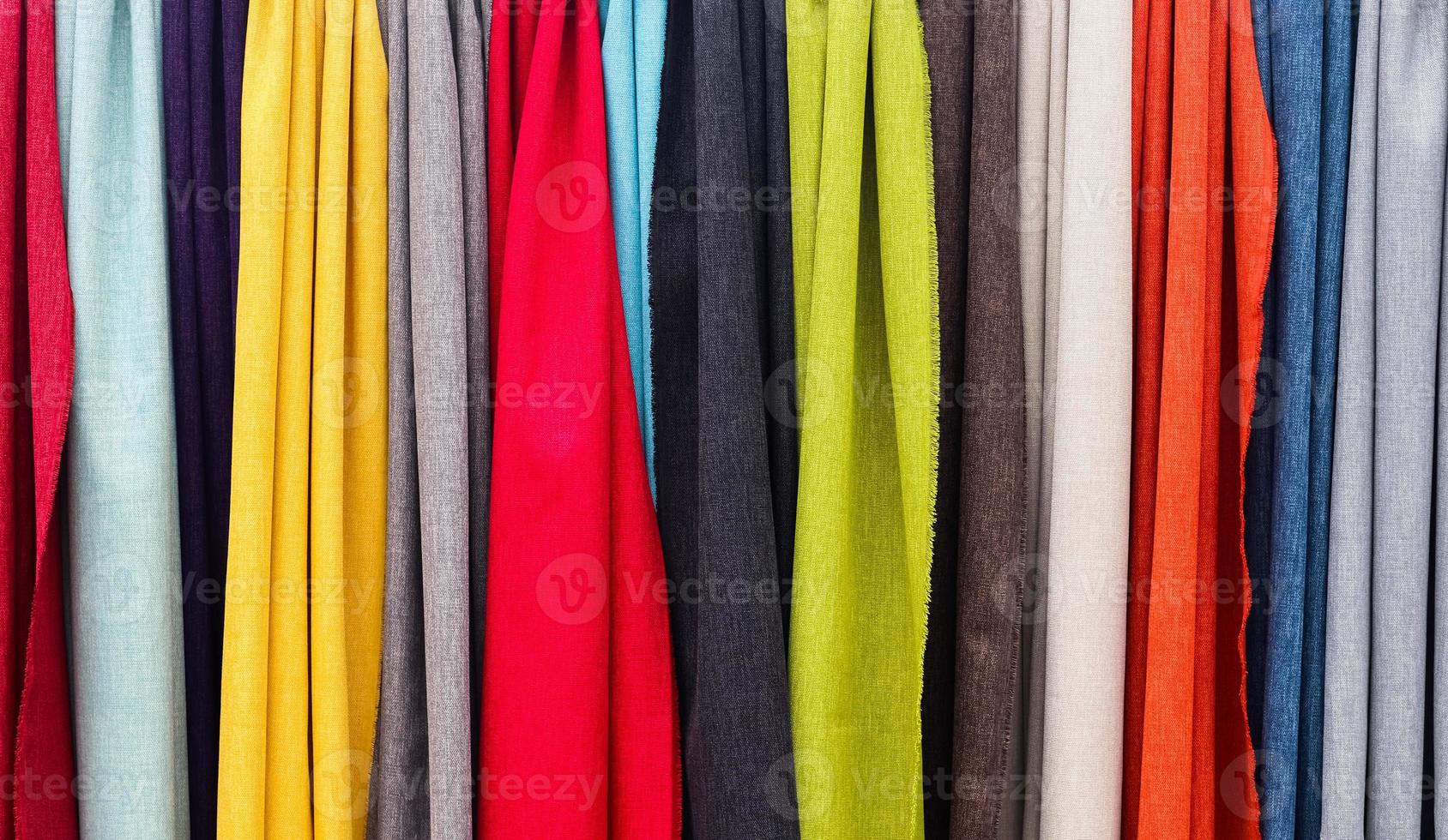 Detailed close up view on samples of cloth and fabrics in different colors found at a fabrics market photo