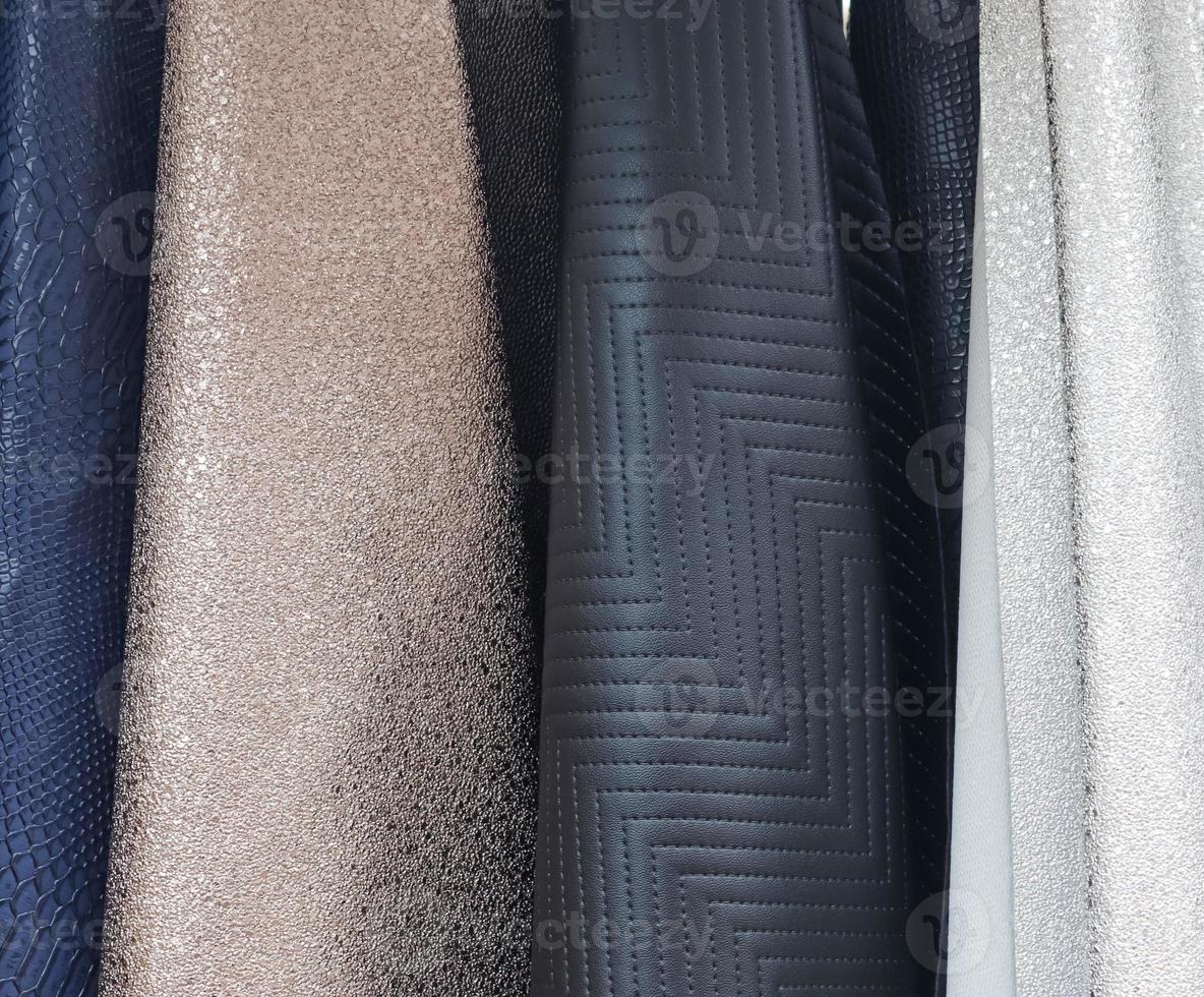 Detailed close up view on samples of cloth and fabrics in different colors found at a fabrics market photo