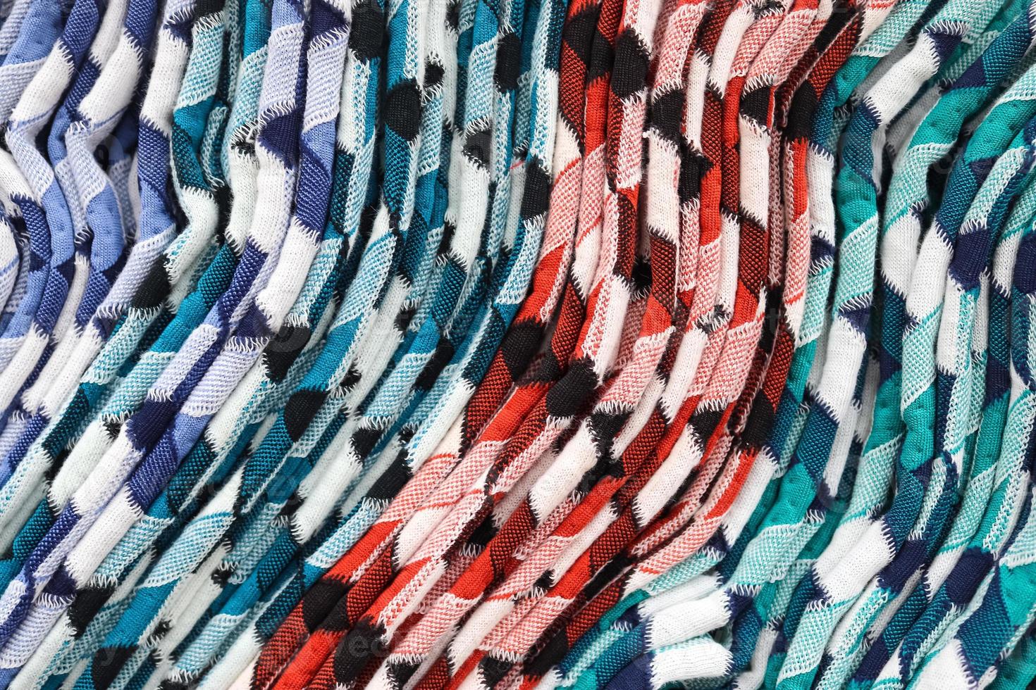Detailed close up view on samples of cloth and fabrics in different colors found at a fabrics market photo