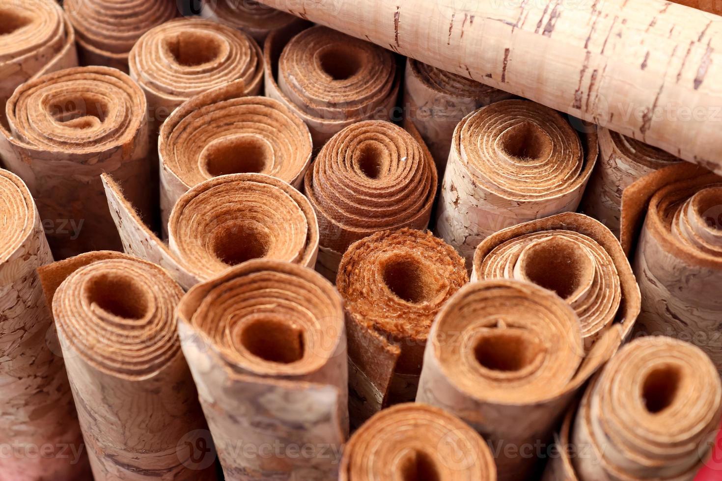 Close up view on rolled samples of cloth and fabrics in different colors found at a fabrics market.. photo