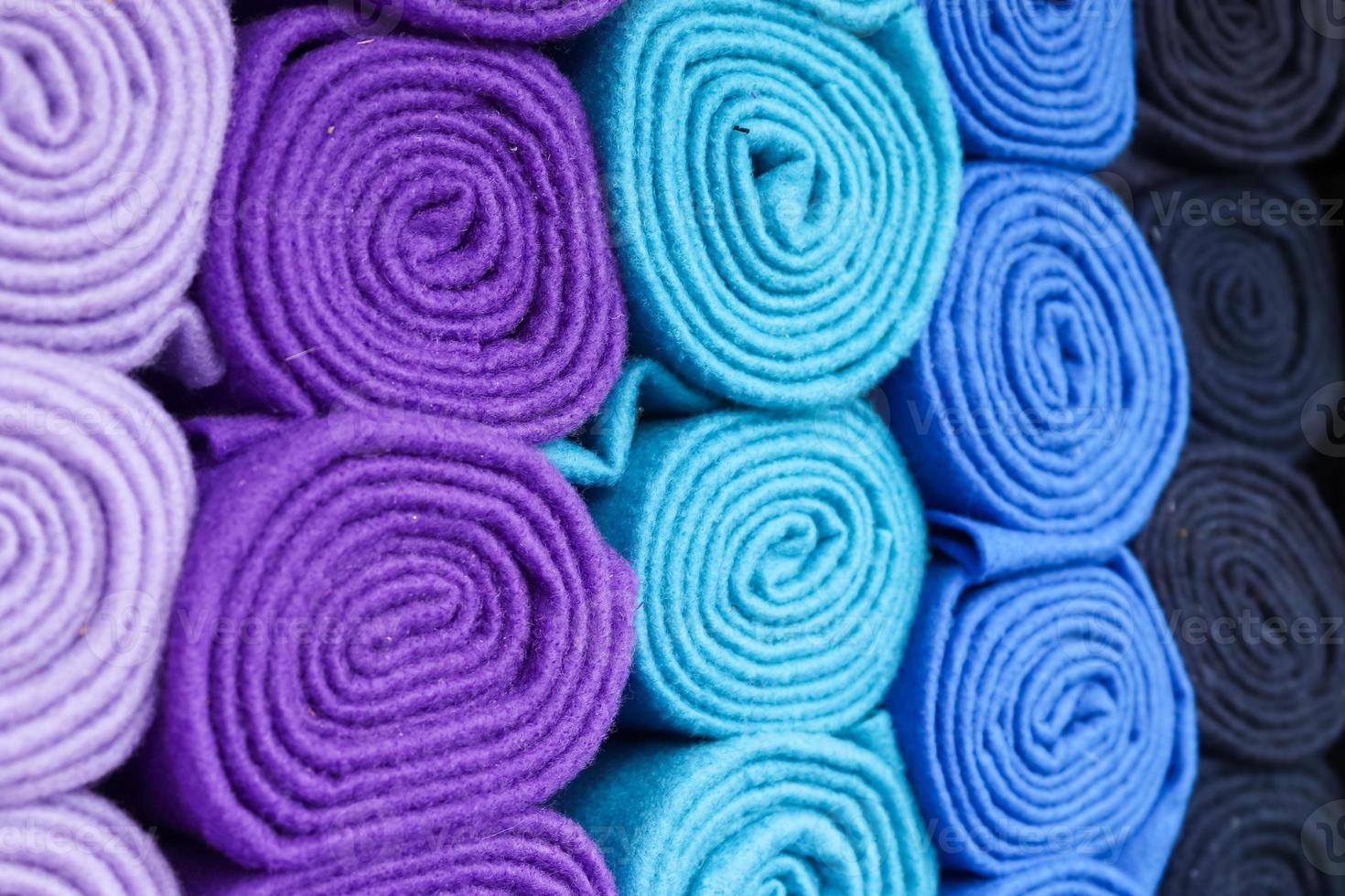 Detailed close up view on samples of cloth and fabrics in different colors found at a fabrics market photo