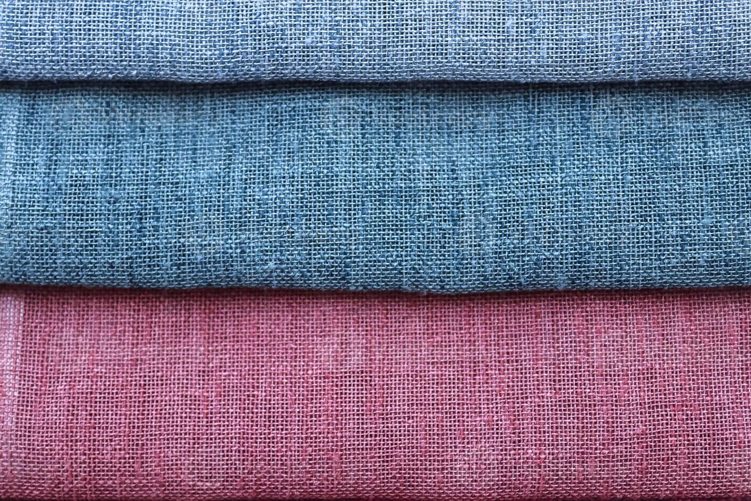 Detailed close up view on samples of cloth and fabrics in different colors found at a fabrics market photo