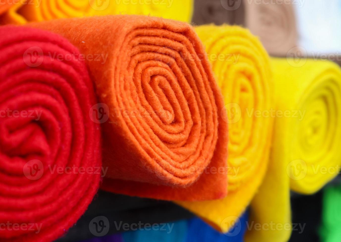 Detailed close up view on samples of cloth and fabrics in different colors found at a fabrics market photo