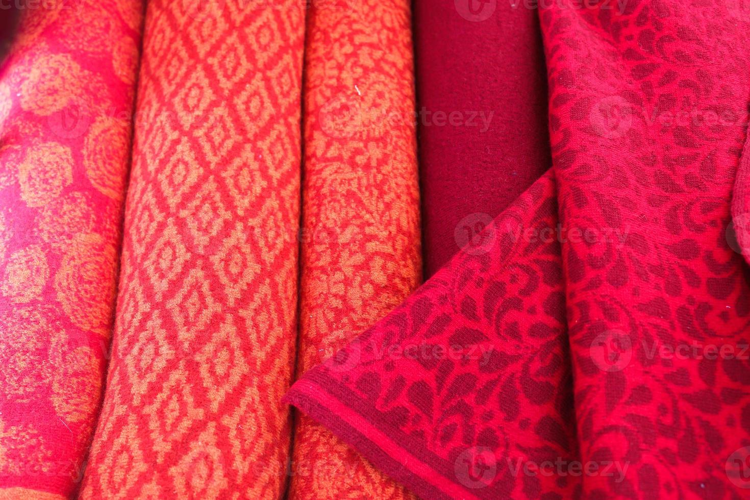 Detailed close up view on samples of cloth and fabrics in different colors found at a fabrics market photo