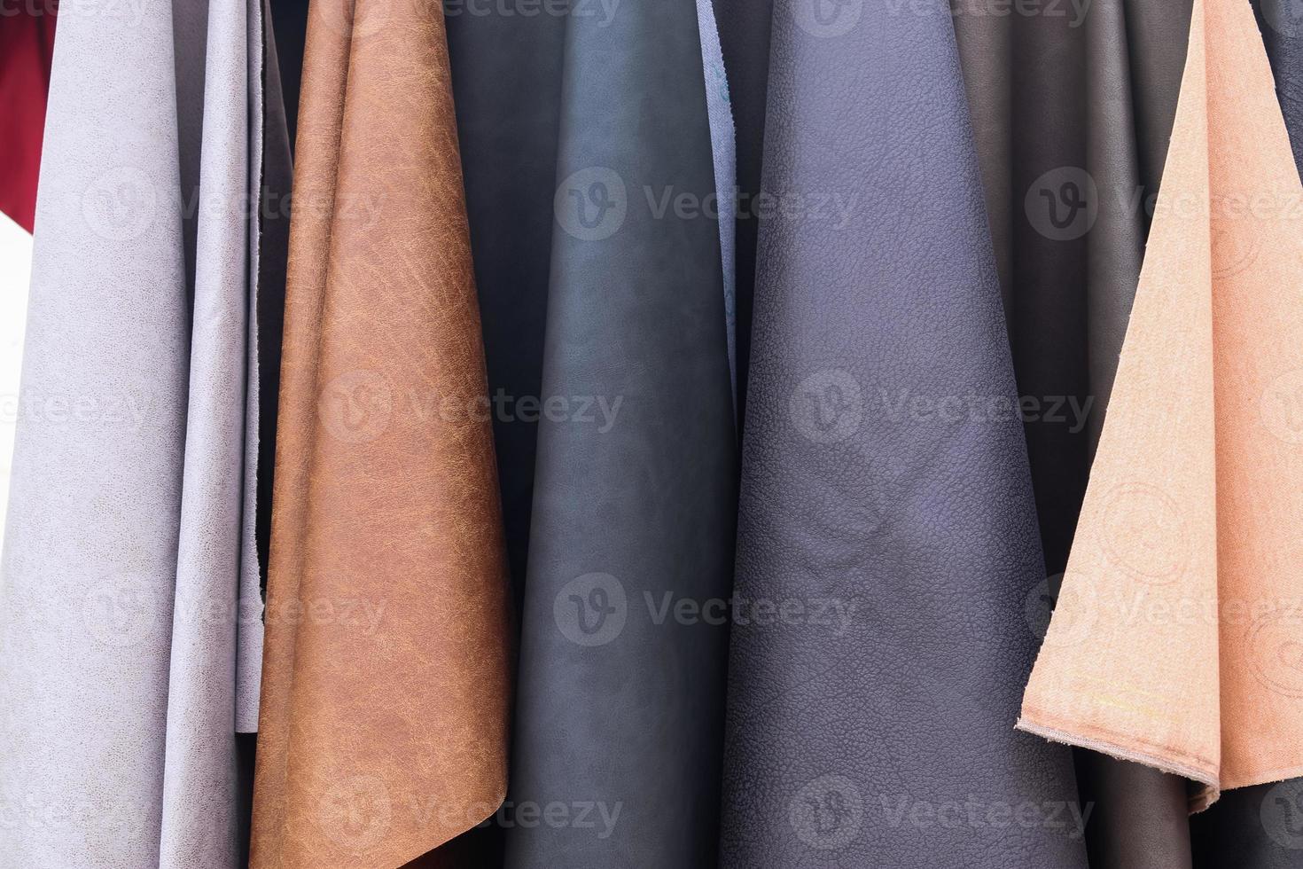 Detailed close up view on samples of cloth and fabrics in different colors found at a fabrics market photo