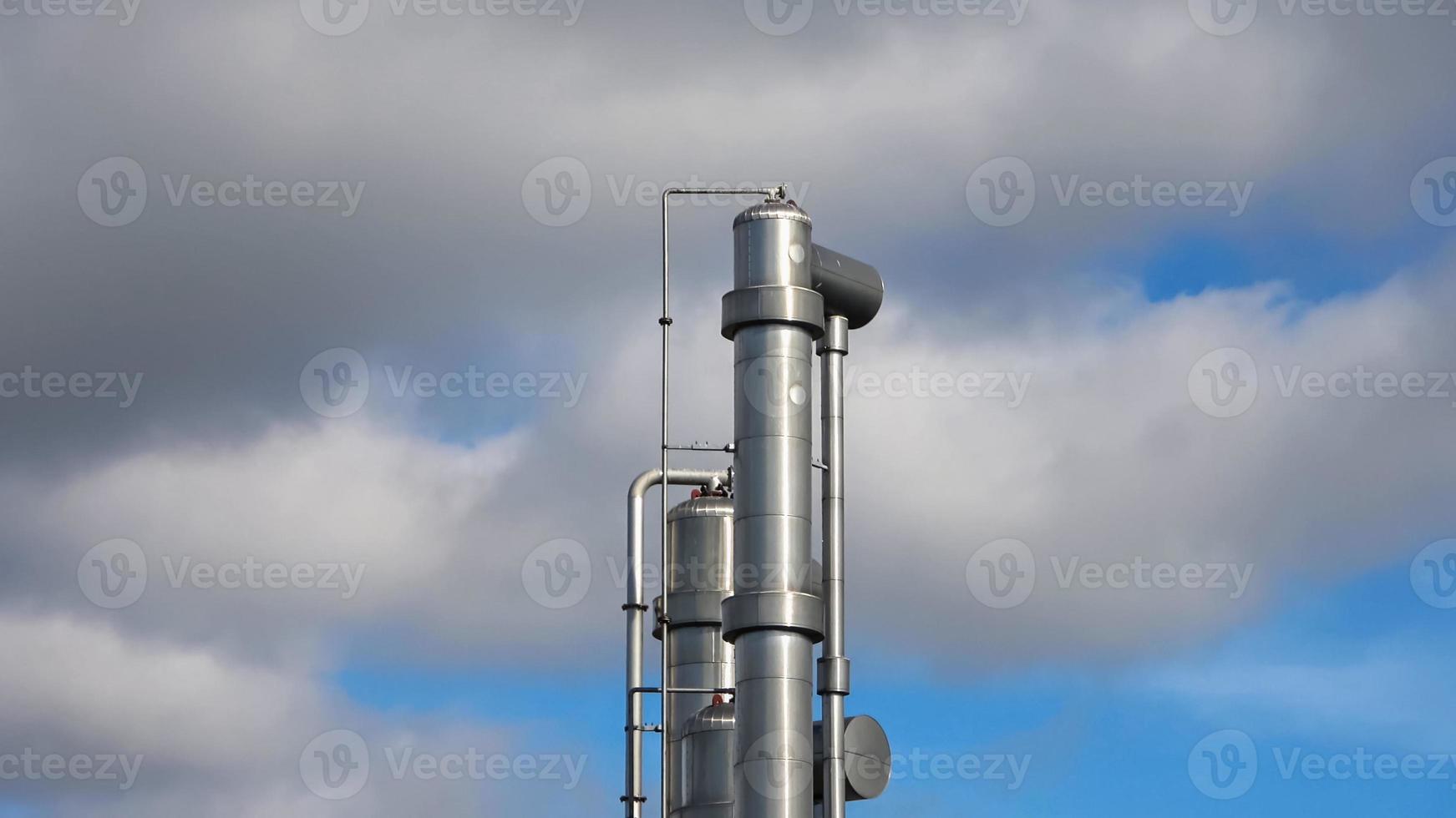 Shining metal industrial plant with many pipes and chimneys. photo
