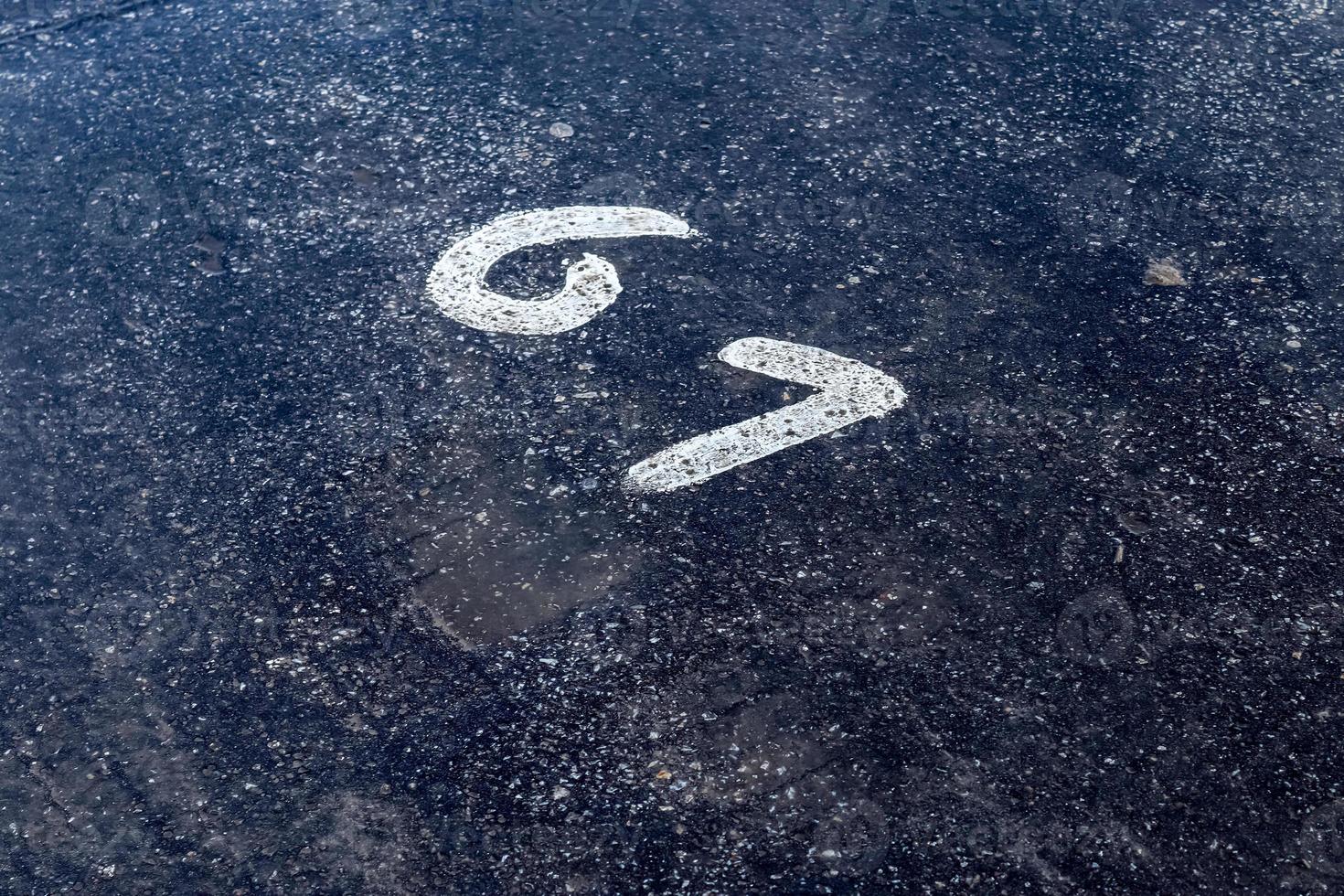 Numbers painted on concrete and asphalt surfaces photo