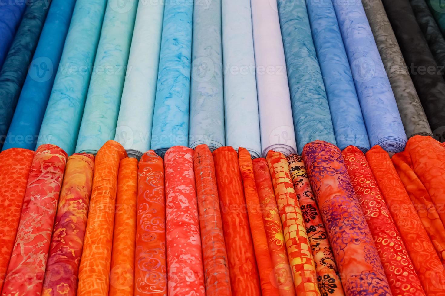 Detailed close up view on samples of cloth and fabrics in different colors found at a fabrics market photo