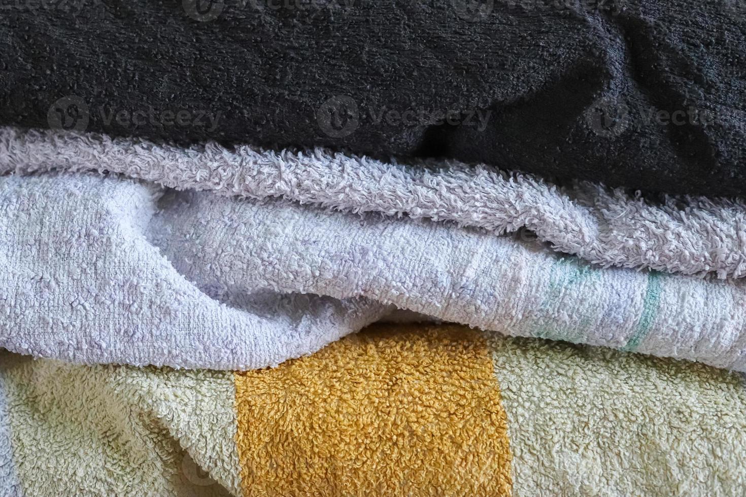 Detailed close up view on samples of cloth and fabrics in different colors found at a fabrics market photo