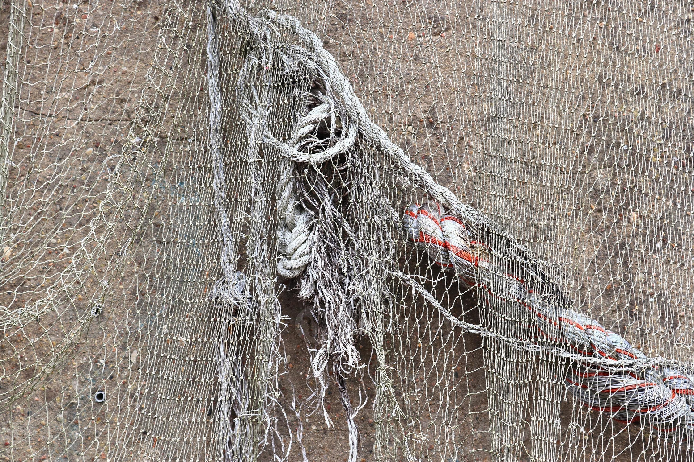 Close up view on a fishing net decoration on an old weathered wall. 9401571  Stock Photo at Vecteezy