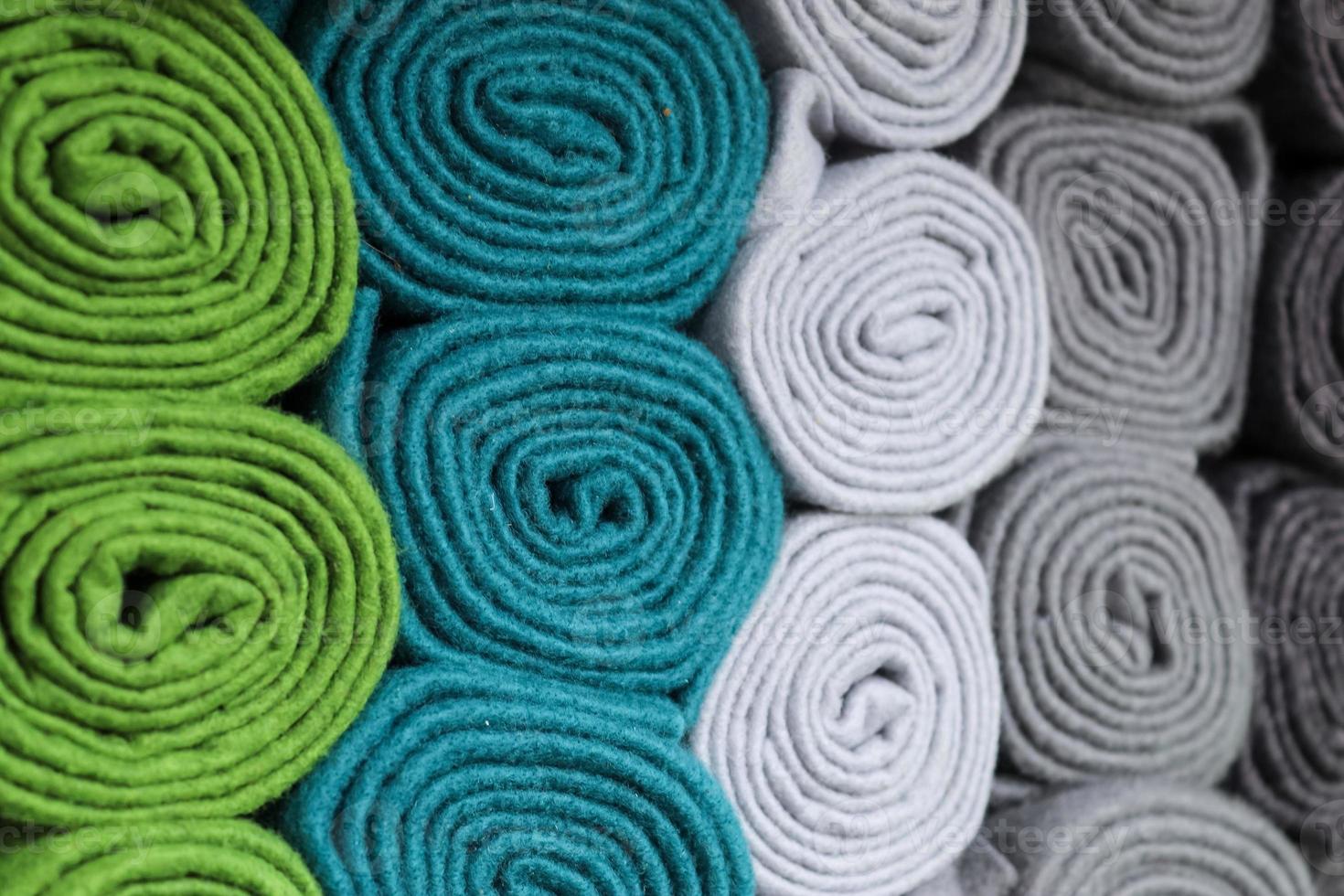 Detailed close up view on samples of cloth and fabrics in different colors found at a fabrics market photo