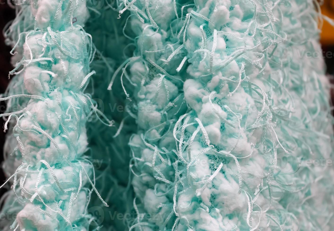 Detailed close up view on samples of cloth and fabrics in different colors found at a fabrics market photo