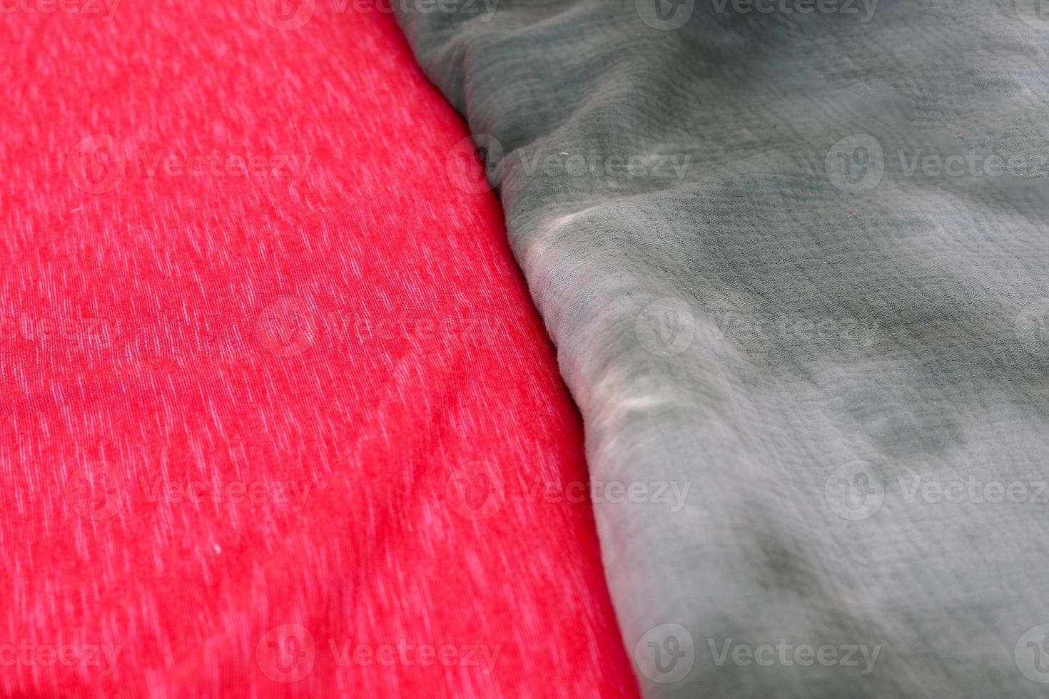 Detailed close up view on samples of cloth and fabrics in different colors found at a fabrics market photo