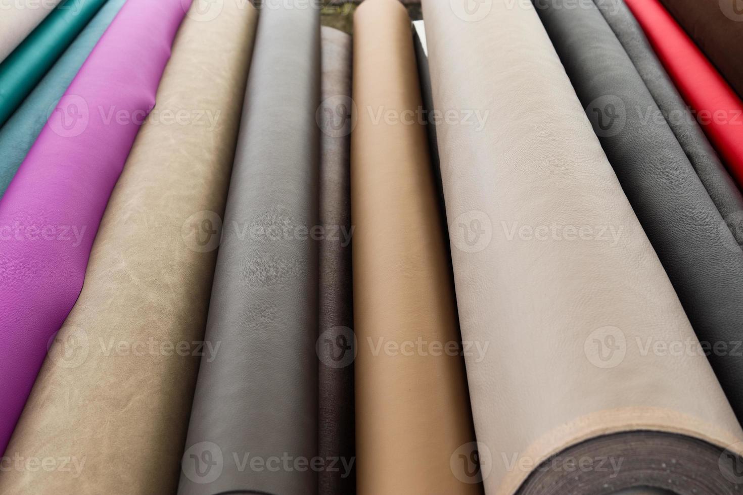 Detailed close up view on samples of cloth and fabrics in different colors found at a fabrics market photo