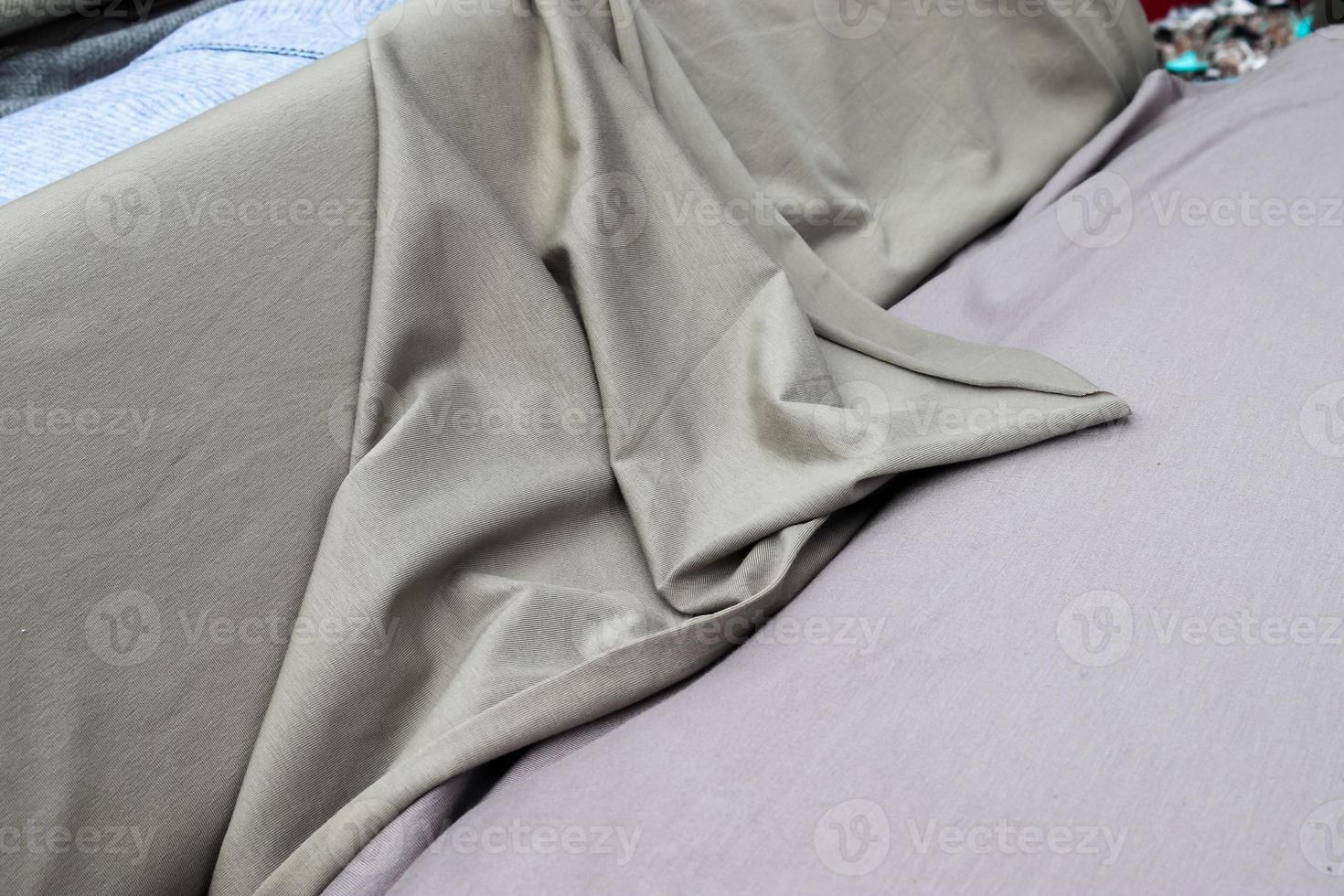 Detailed close up view on samples of cloth and fabrics in different colors found at a fabrics market photo