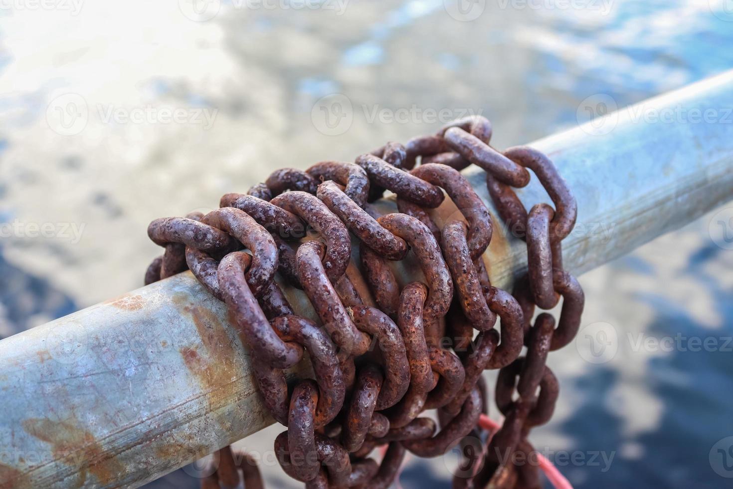 Rusty chain around metal bars at the port of Kiel. photo