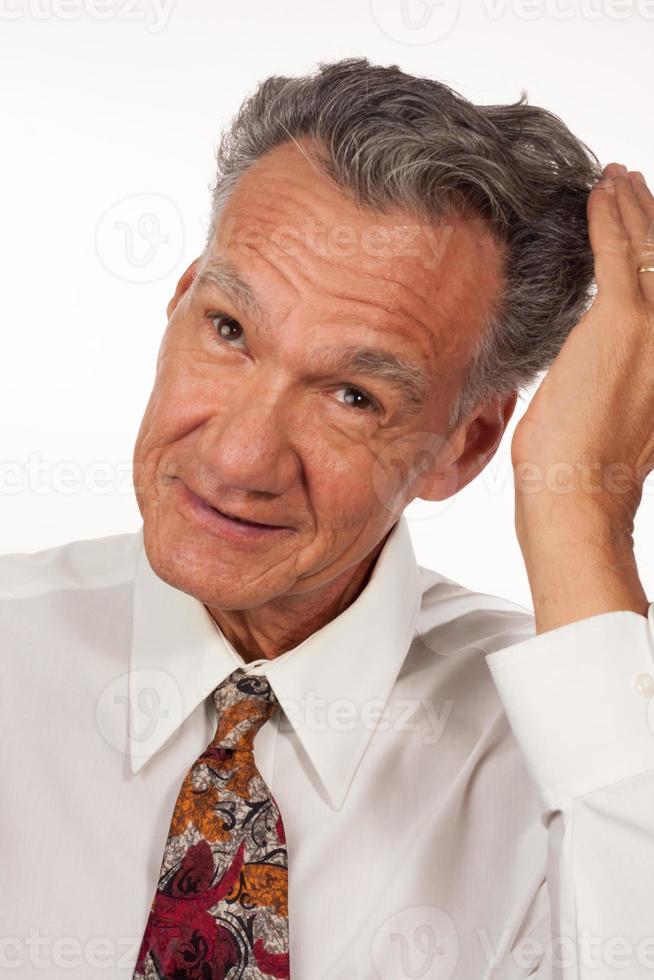 Mature man 60 plus running his hands through his hair photo