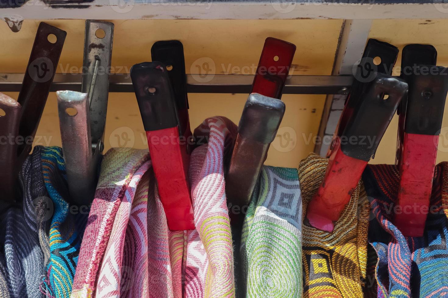 Detailed close up view on samples of cloth and fabrics in different colors found at a fabrics market photo