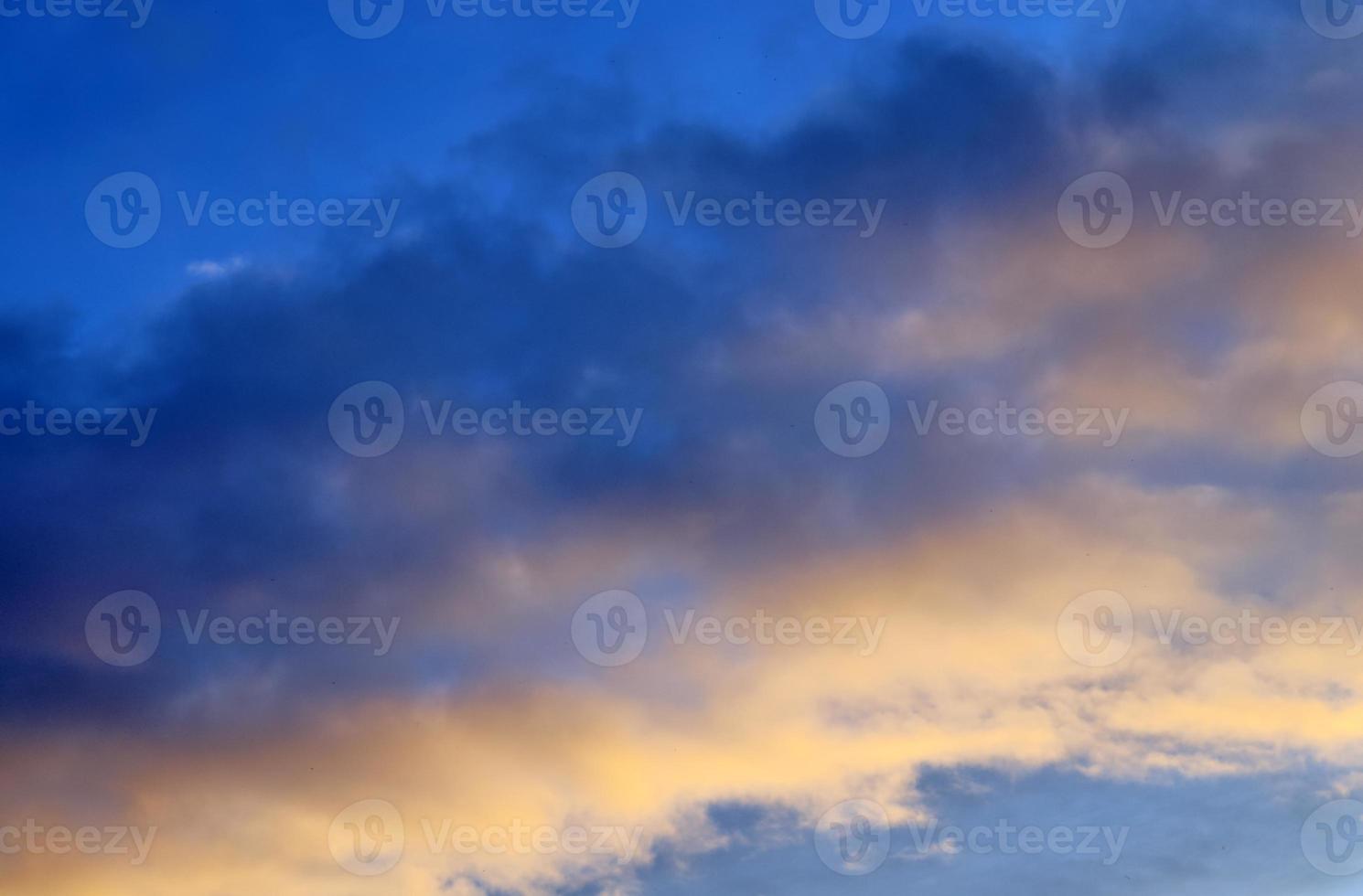 Beautiful panorama of orange and yellow clouds at sunrise photo