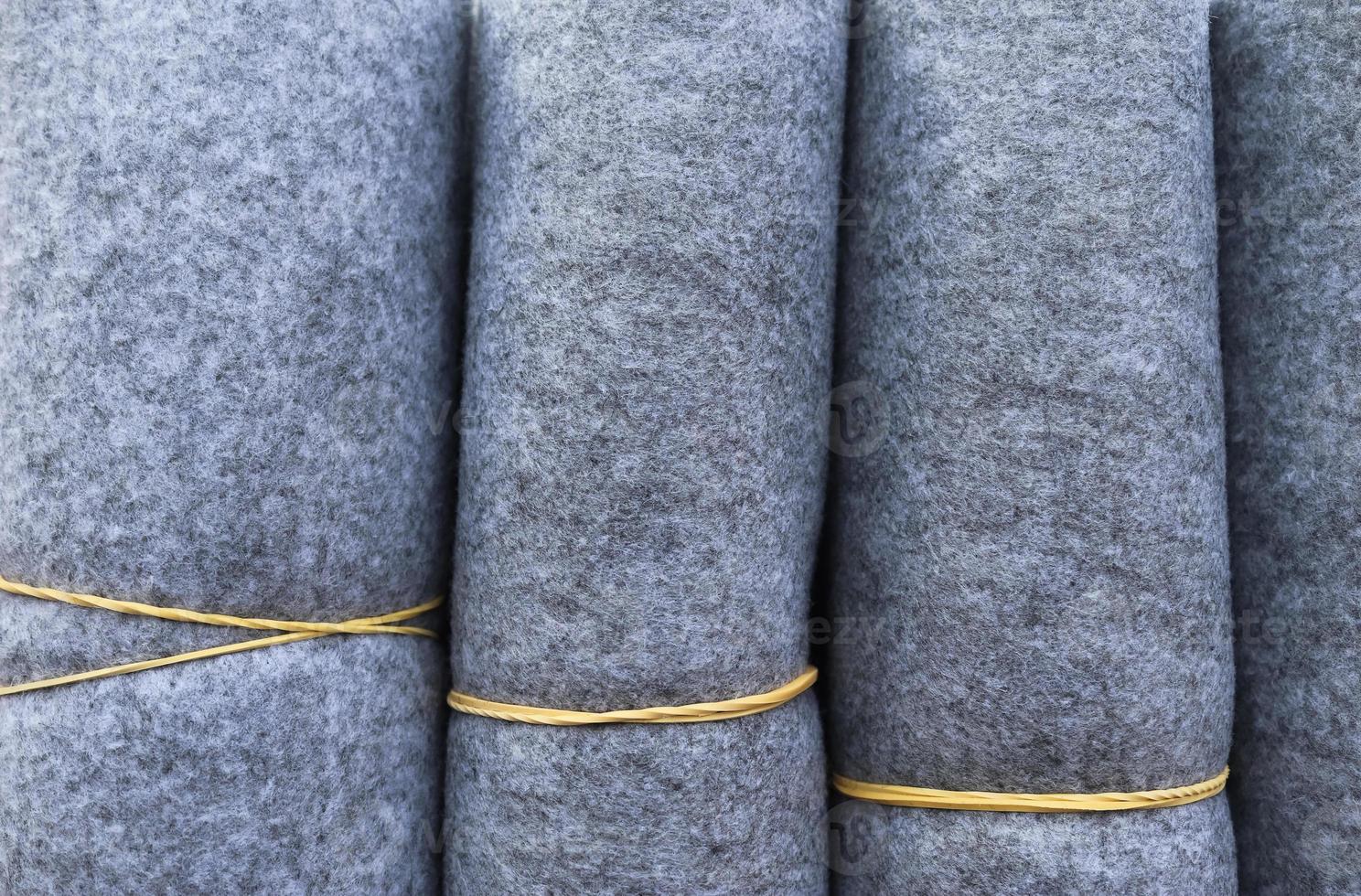 Detailed close up view on samples of cloth and fabrics in different colors found at a fabrics market photo