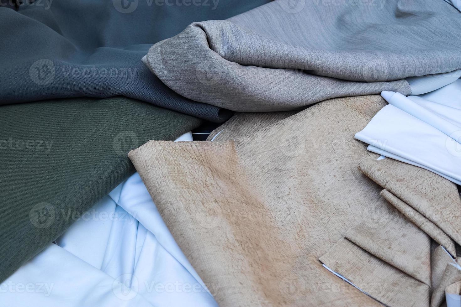Detailed close up view on samples of cloth and fabrics in different colors found at a fabrics market photo