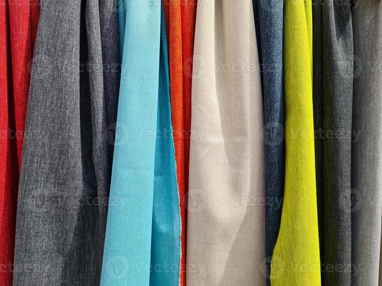 Detailed close up view on samples of cloth and fabrics in different colors found at a fabrics market photo