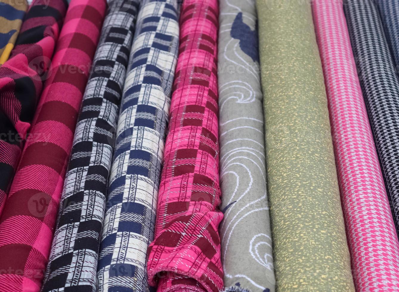 Detailed close up view on samples of cloth and fabrics in different colors found at a fabrics market photo
