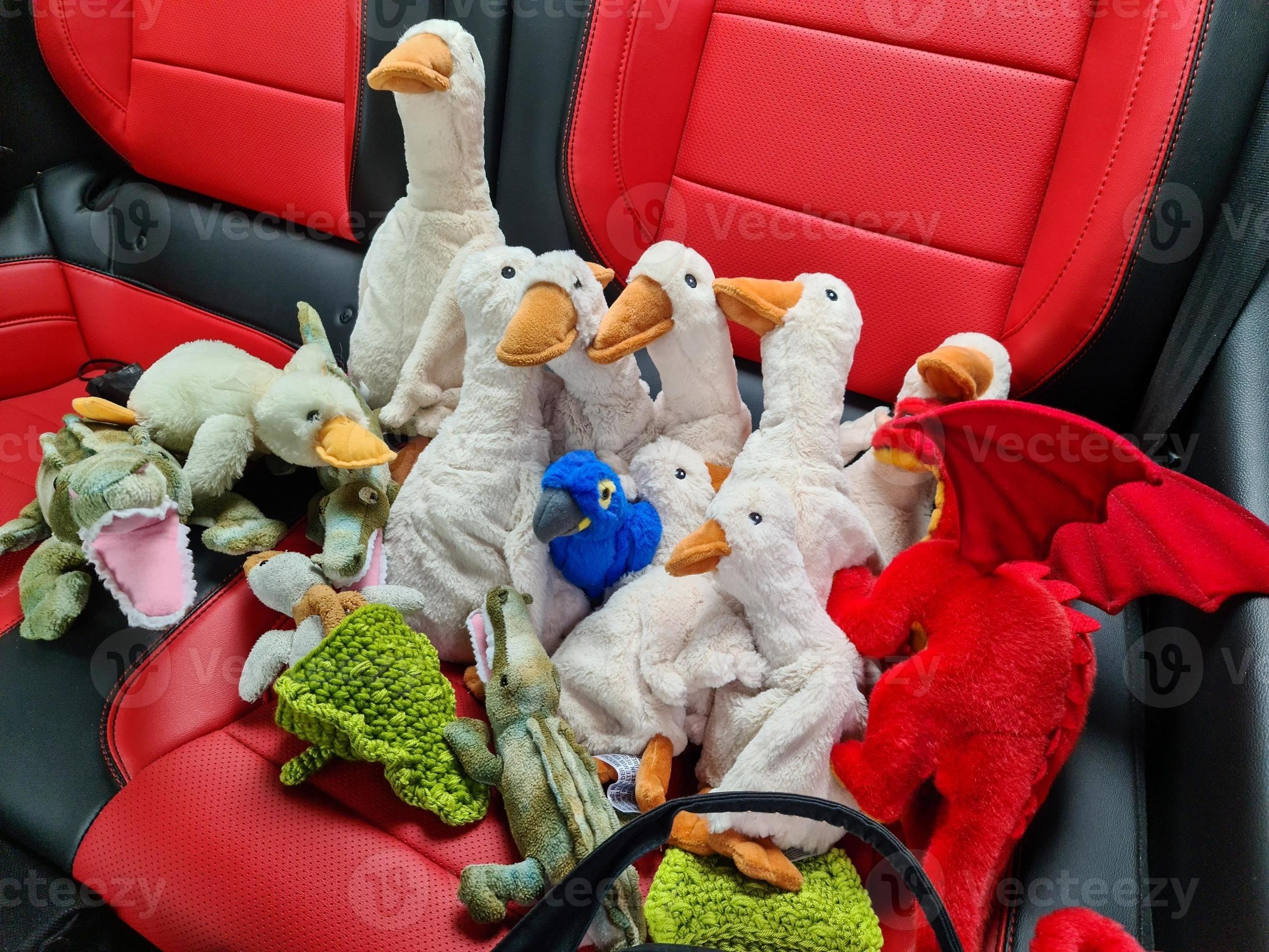Numerous stuffed animals such as geese, ducks, crocodiles and dragons sit together on red leather seats. 9404530 Stock Photo at Vecteezy Numerous stuffed animals such as geese, ducks, crocodiles and dragons sit together on red leather seats. 9404530 Stock Photo at Vecteezy