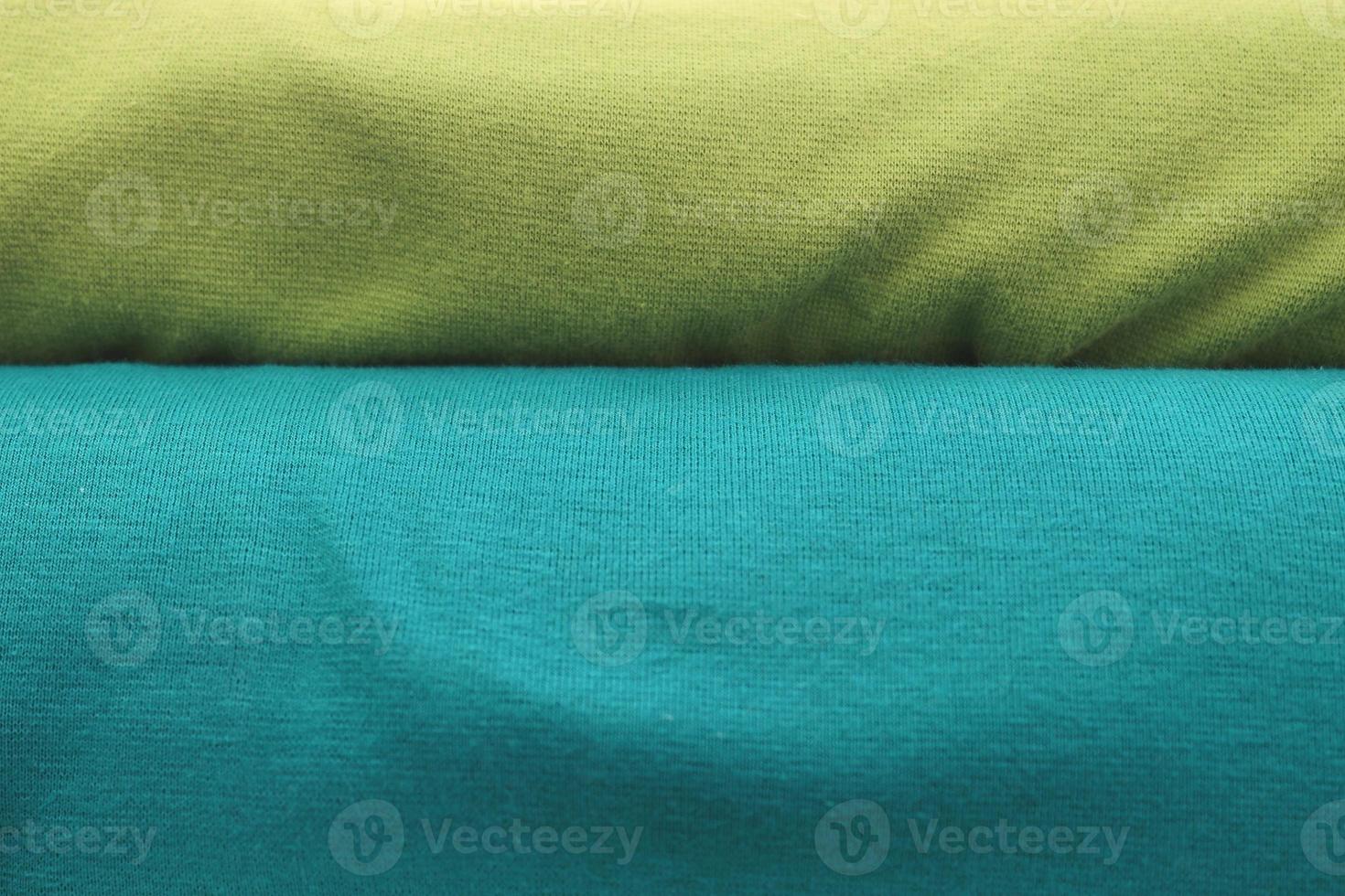 Detailed close up view on samples of cloth and fabrics in different colors found at a fabrics market photo