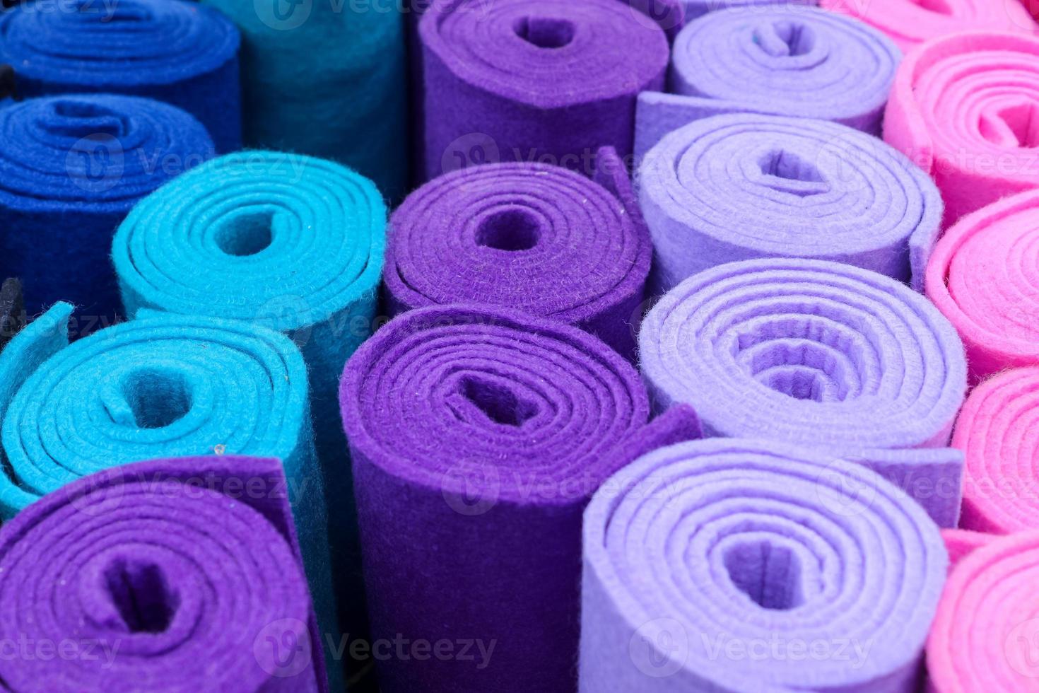 Detailed close up view on samples of cloth and fabrics in different colors found at a fabrics market photo
