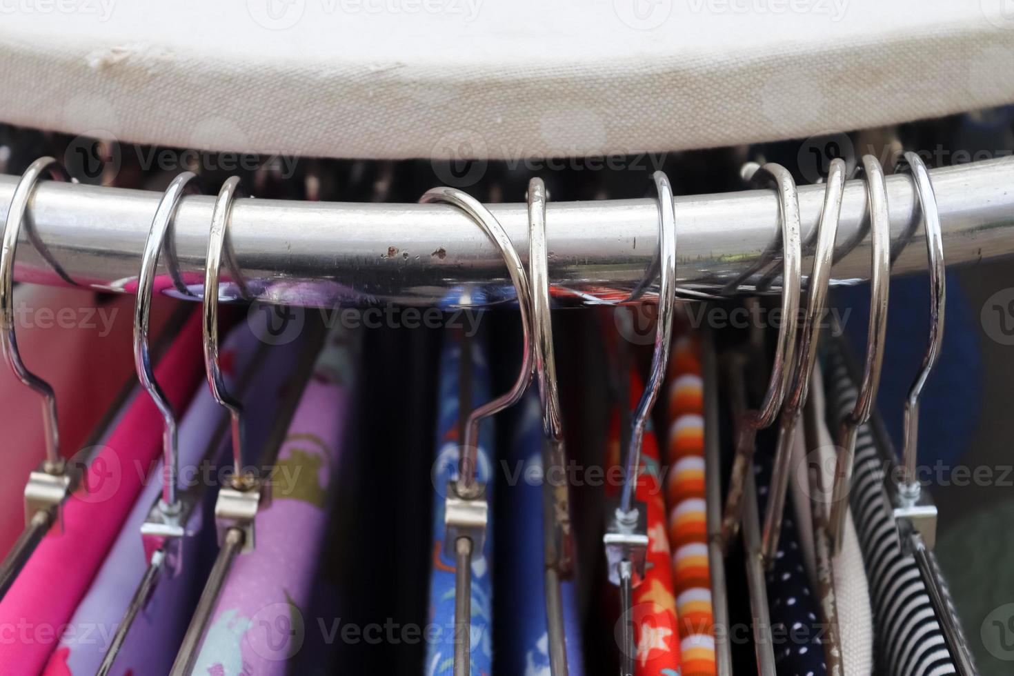 Detailed close up view on samples of cloth and fabrics in different colors found at a fabrics market photo