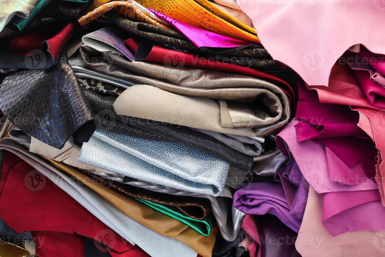 Detailed close up view on samples of cloth and fabrics in different colors found at a fabrics market photo