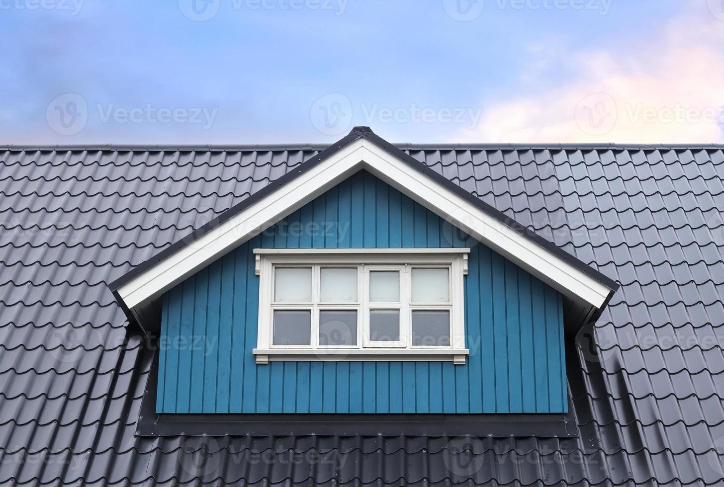 Roof window in velux style with roof tiles - icelandic architecture. photo