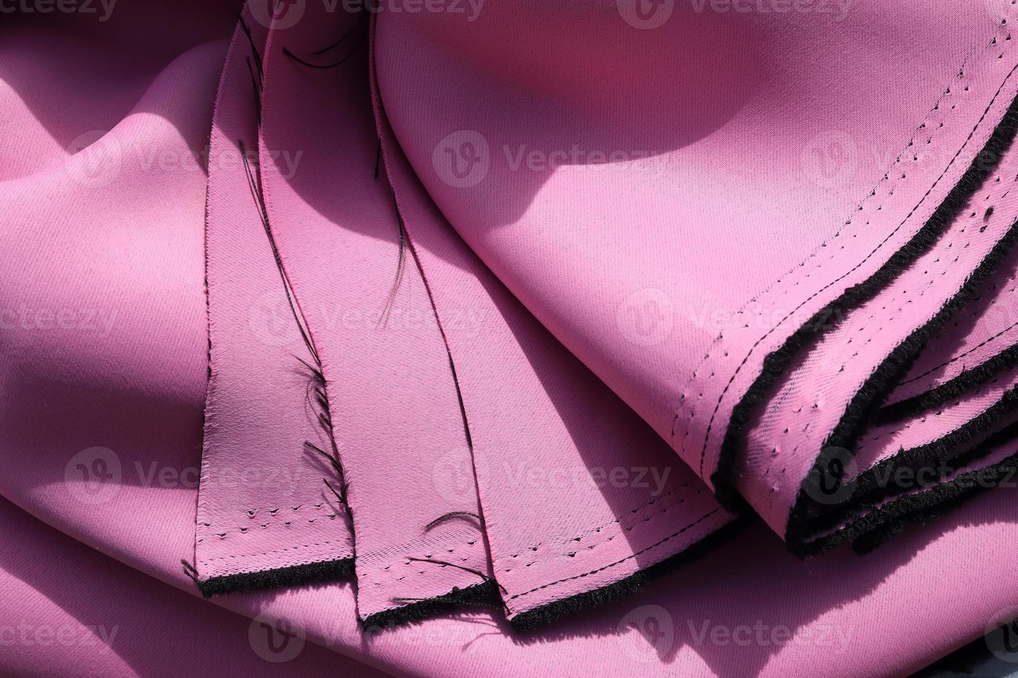 Detailed close up view on samples of cloth and fabrics in different colors found at a fabrics market photo